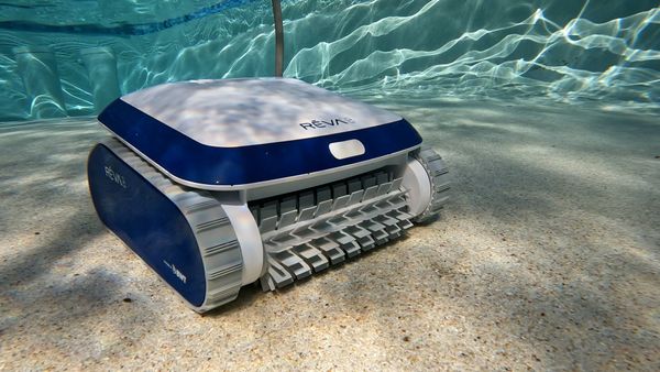 Aquabot REVA robotic pool cleaner sitting on a pool deck