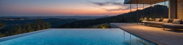 Infinity-edge backyard pool overlooking the hills at sunset