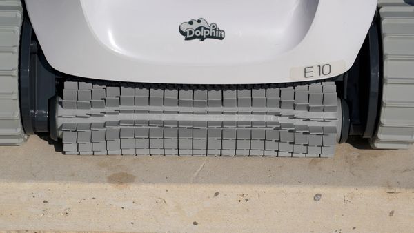 Dolphin E10 brush cleaning near the base of the wall