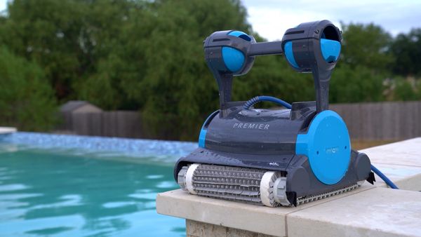 Dolphin Premier robotic pool cleaner sitting on the pool deck after a test run
