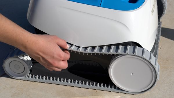 Close-up of a hand touching the Dolphin Proteus DX3 wheel tracks