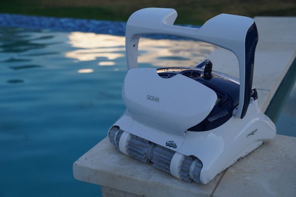 Dolphin Sigma on the pool ledge with its top lid open showing the filter