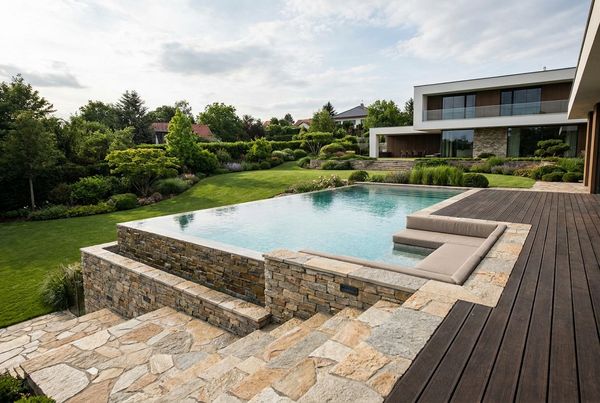Above-ground pool styled with composite decking and glass railing