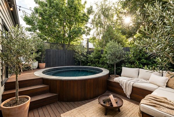 Above-ground pool styled with a stacked-stone skirt