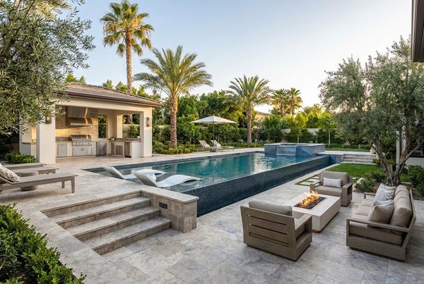 Luxury backyard makeover with a cohesive stone and wood palette