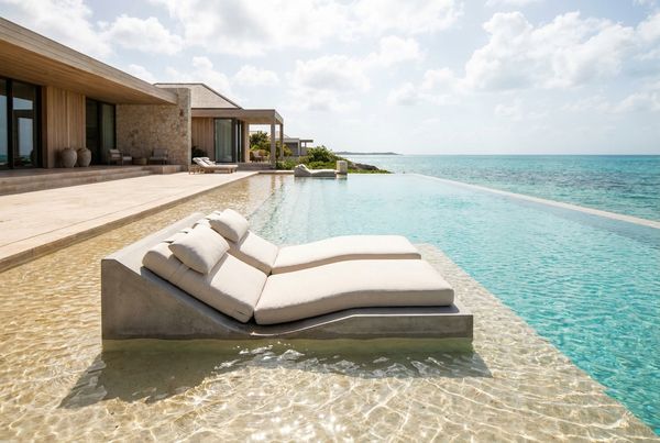 Beach entry pool with an in-water lounger on the shallow tanning shelf