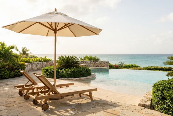 Beach entry pool with a large umbrella shading the shallow ledge