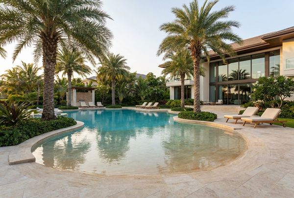 Resort-style beach entry pool with a wide shelf and infinity edge