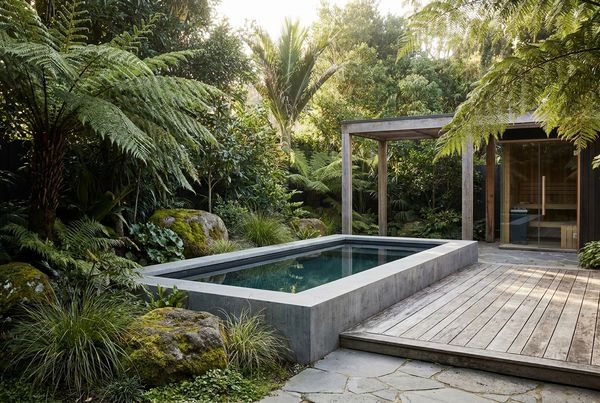 Courtyard cold plunge surrounded by potted greenery