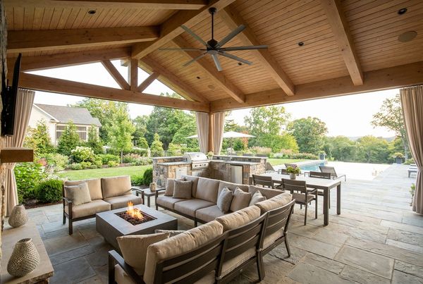 Covered patio with a slow-turning ceiling fan over a lounge area