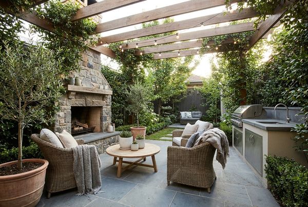 Covered patio with a stacked-stone fireplace and lounge seating