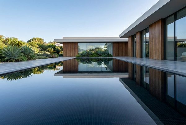 Black bottom pool with a mirror-like reflection of the surroundings