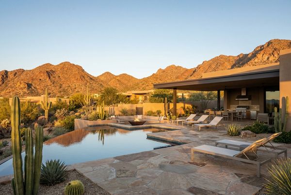 Desert pool with a fire feature glowing at night