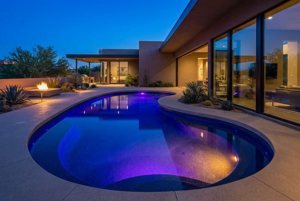 Fiberglass pool with a wide molded tanning ledge and loungers