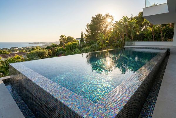 Full iridescent glass tile pool shimmering in the sun