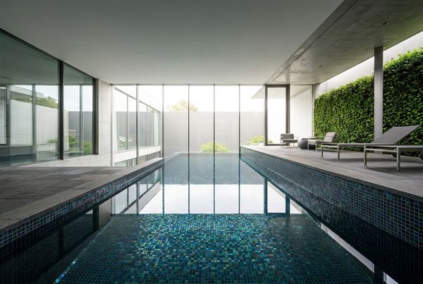 Dark glass tile modern pool with a sleek reflective surface