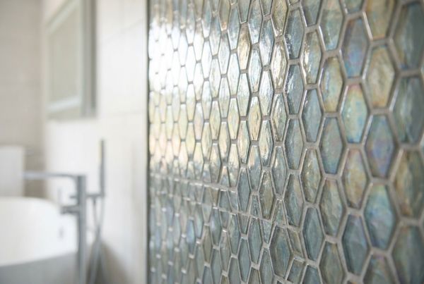Close-up of iridescent glass pool tile shimmering underwater