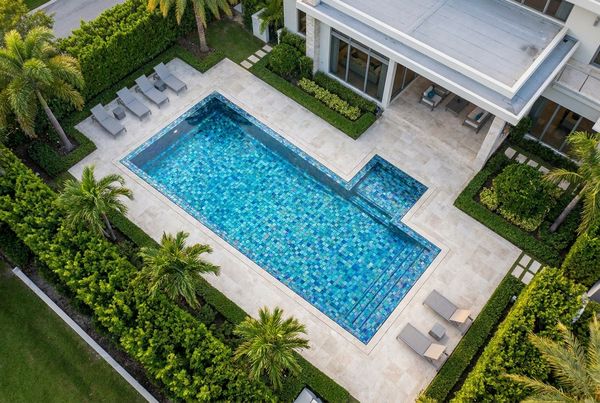 Dark glass tile pool with a modern rectilinear shape
