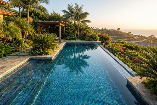 Modern glass tile pool with clean coping and deck