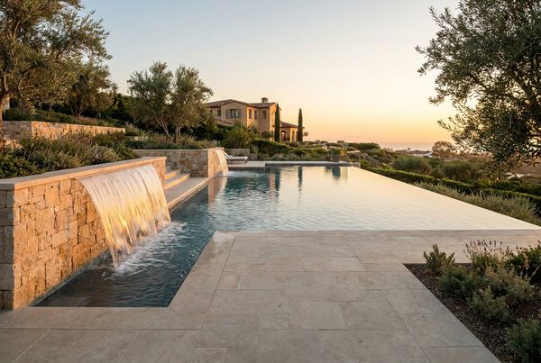 Custom gunite pool with a vanishing edge and a sheer-descent water feature