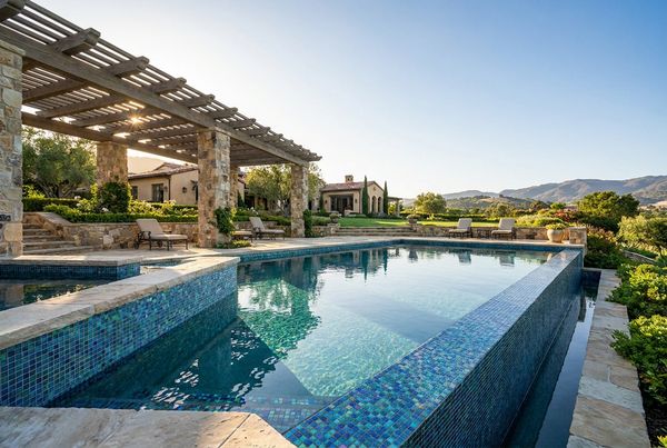 Gunite pool with a glass mosaic tile interior and rich blue water