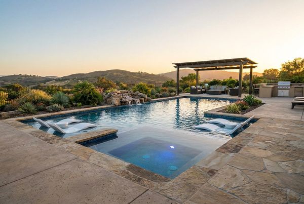 Luxury gunite pool loaded with fire bowls, spa, tanning ledge and water features