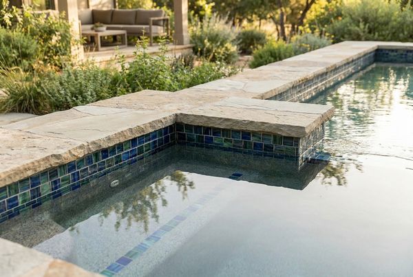 Freeform gunite pool with a natural boulder waterfall