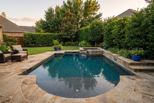 Gunite pool with a gentle beach entry sloping into the water