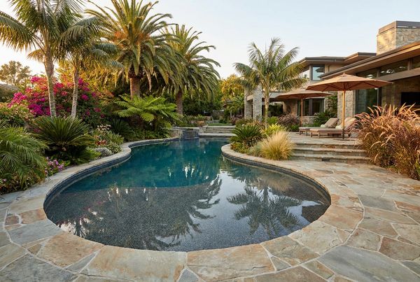 Geometric gunite pool with glass mosaic tile lining the interior