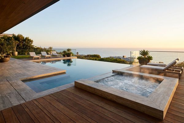 Portable hot tub on a raised timber deck with a step surround