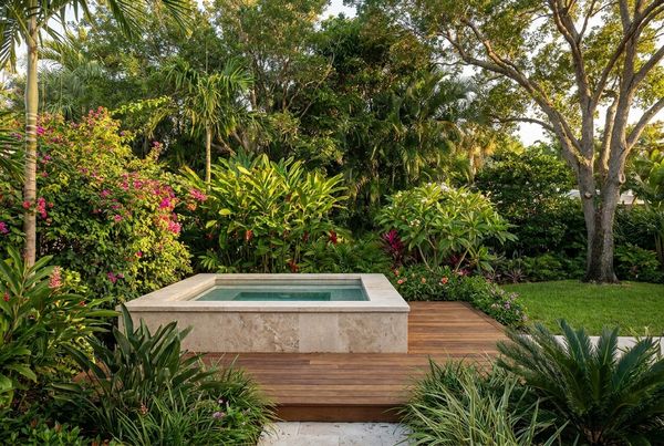 Hot tub set into a lush garden with layered planting