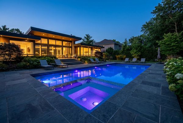 Inground pool with a raised spa and spillover