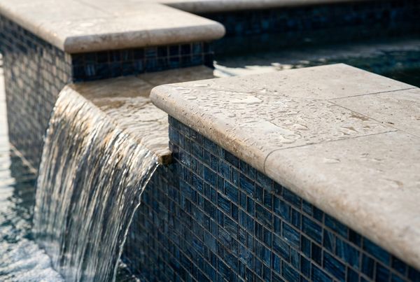 Inground pool with pebble finish and blue water