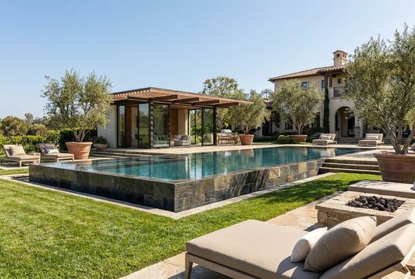 Inground pool with a paver patio and pergola