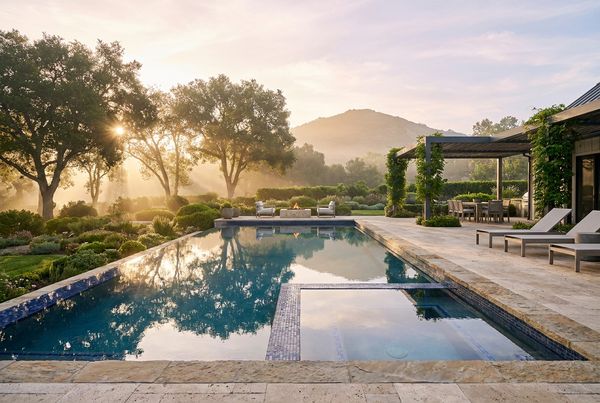 Inground pool with a full outdoor kitchen and dining area