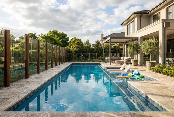 Fenced family pool with a self-closing gate enclosing the shallow play area