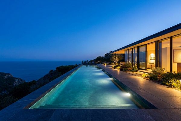 Lap pool in a paved courtyard with clean coping
