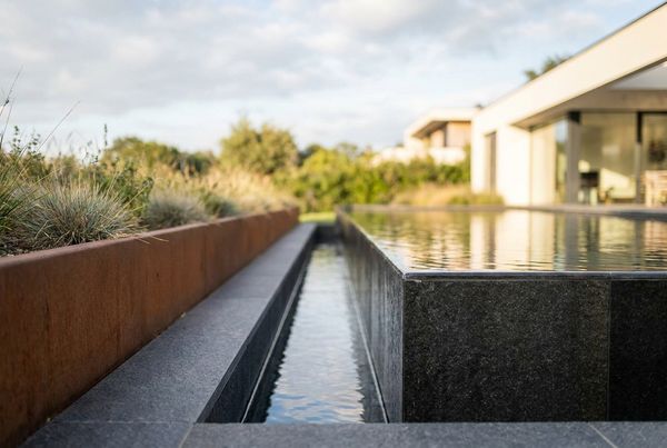 Modern lap pool with a full-length bench along one wall