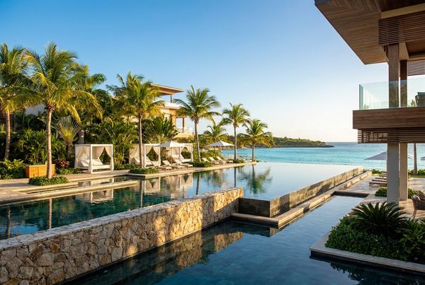 Luxury pool lit dramatically at dusk