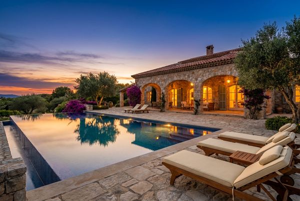 Mediterranean pool glowing warm at dusk