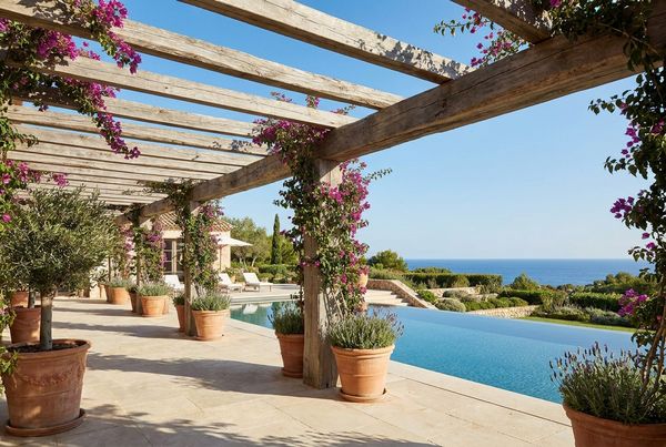 Mediterranean pergola shading a warm-toned poolside seating area