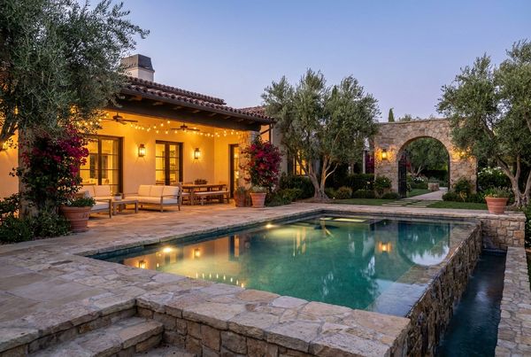 Olive trees and gravel surrounding a Mediterranean pool
