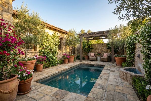 Mediterranean courtyard pool framed by stucco walls