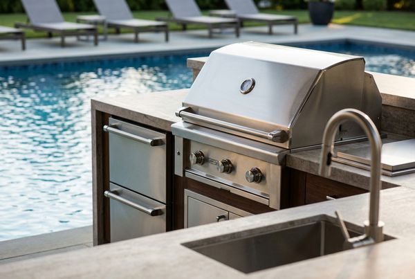 Close-up of stainless steel built-in grill and appliances in an outdoor kitchen