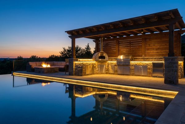 Poolside outdoor kitchen with a waterfall-edge quartz counter