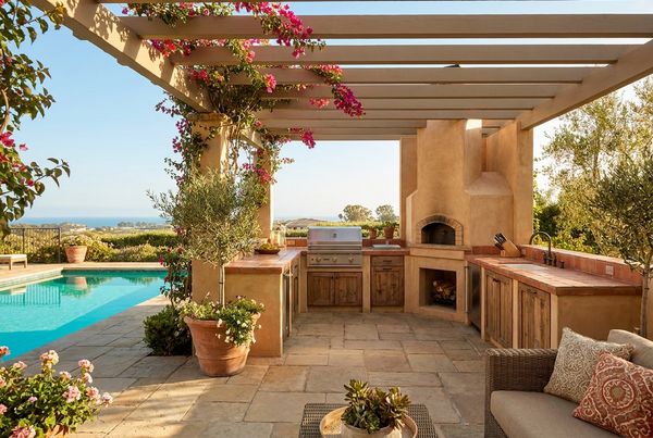 Poolside outdoor kitchen with a poured-concrete counter and modern lines