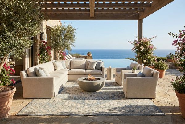 Backyard patio with a large outdoor rug and a sectional sofa