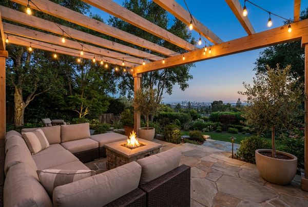 Backyard patio glowing under warm string lights at dusk