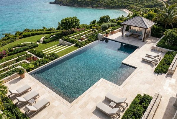 Aerial view of a pebble finish pool in a landscaped yard