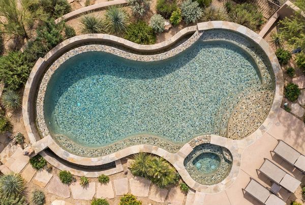 Tan pebble finish pool with a natural lagoon look